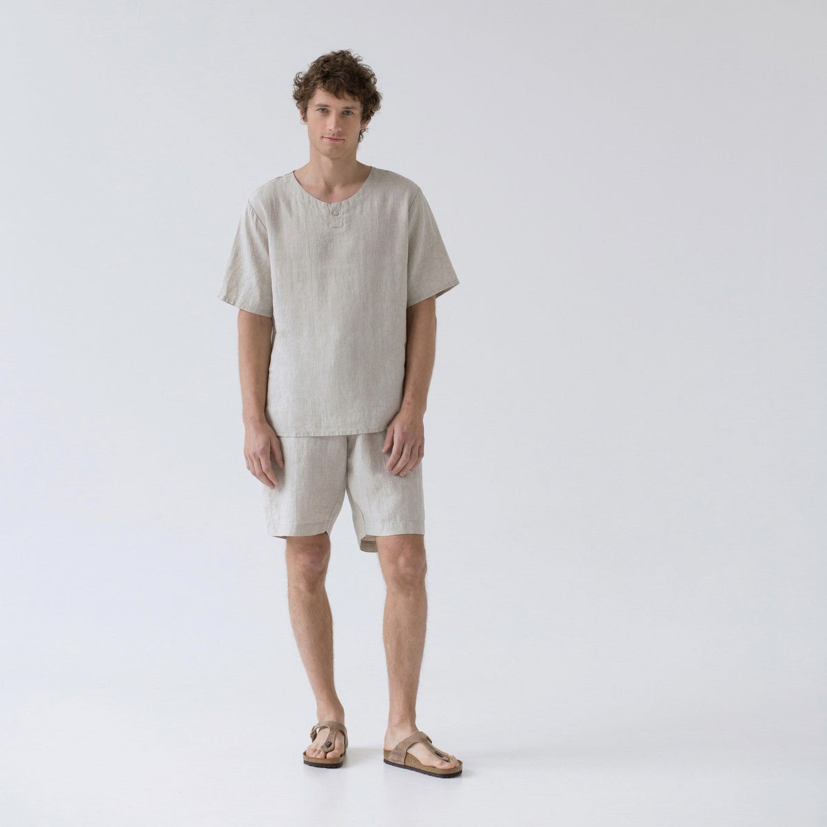 Man in the melange Fern linen pyjama set by Linen Tales, short sleeved top and drawstring shorts