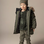 Boy in a khaki double layer merino wool beanie by Lenne
