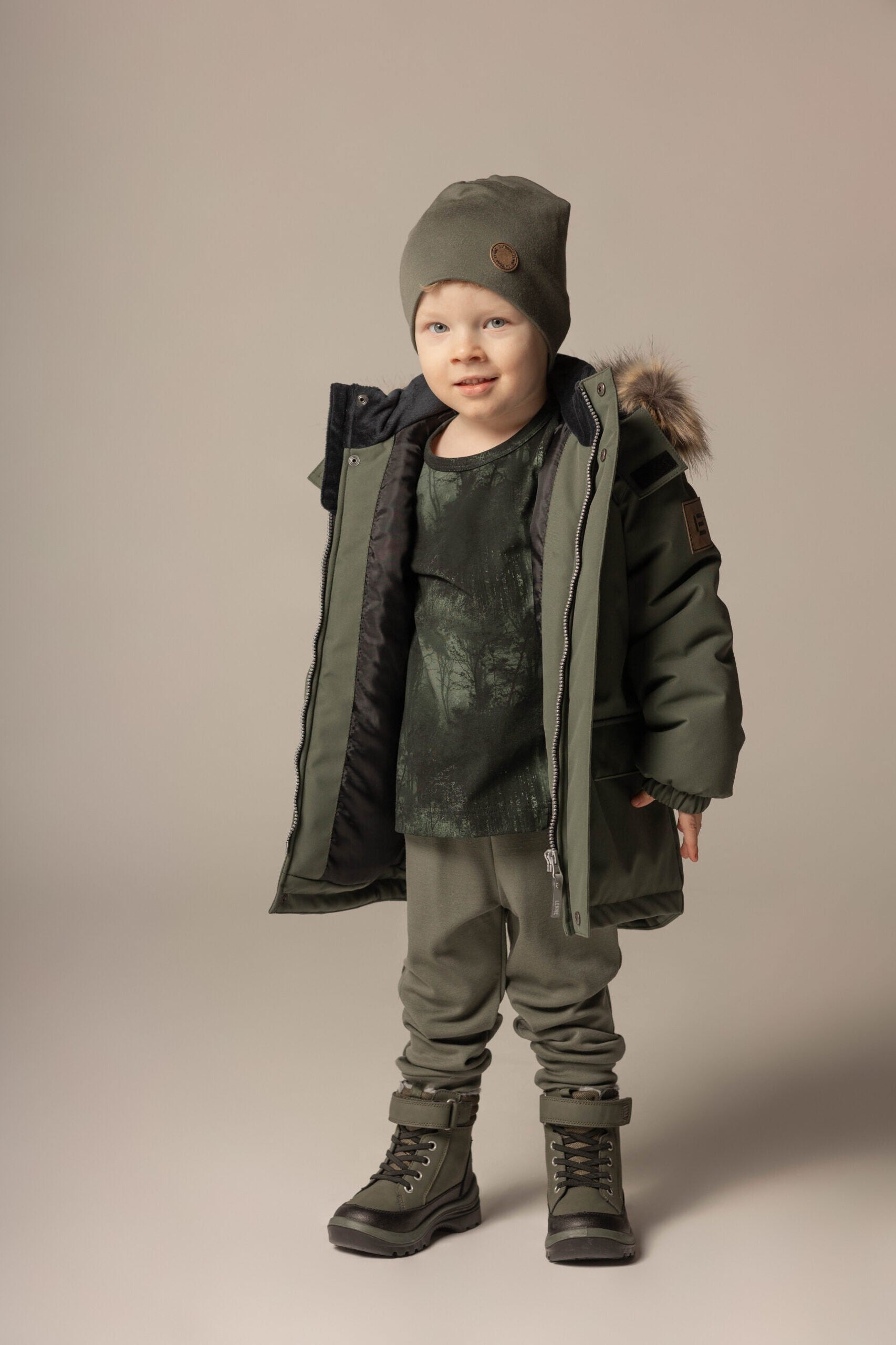 Boy in a khaki double layer merino wool beanie by Lenne