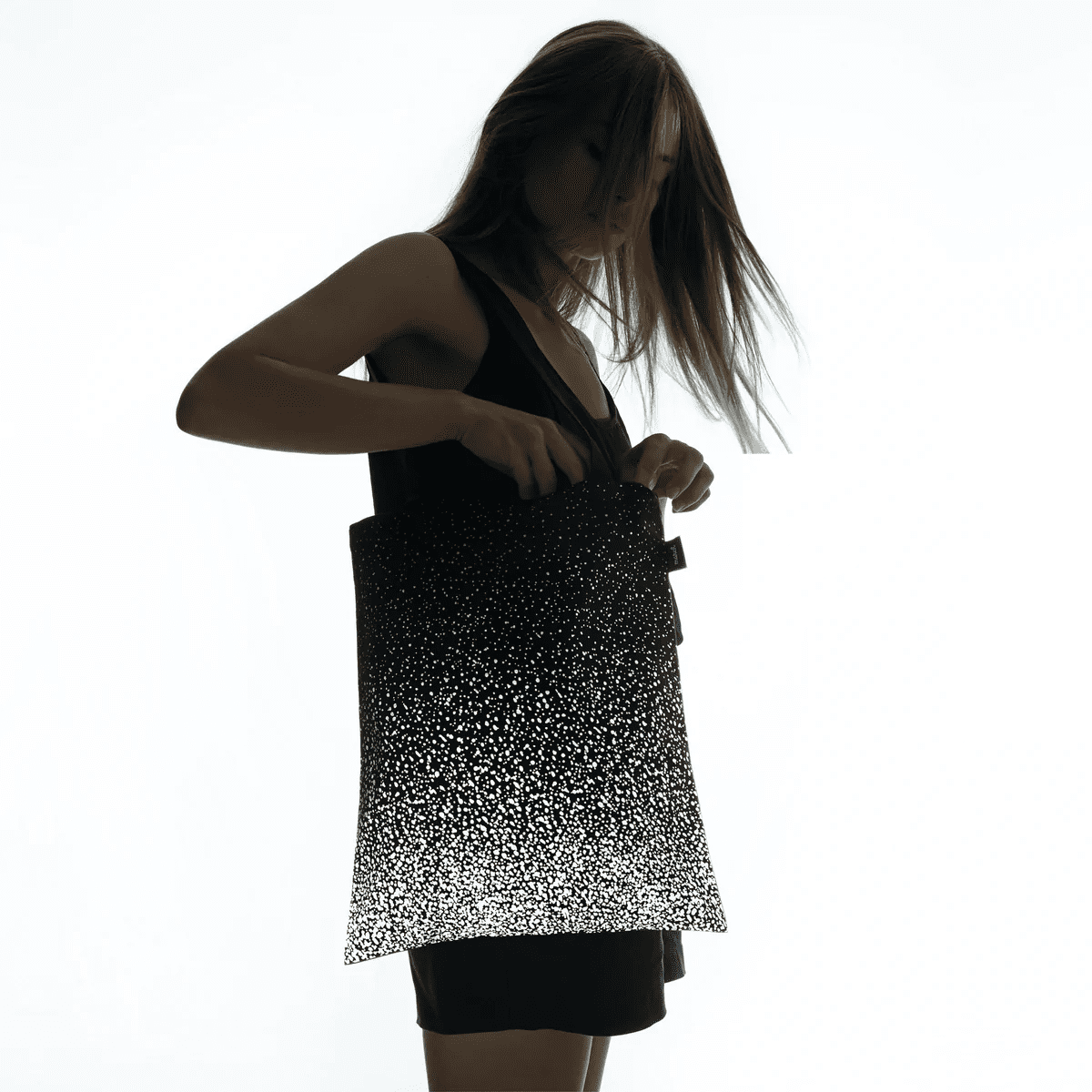 SPLASH reflective tote bag with a space print by MARCH Design Studio, studio view