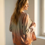 Side view of the Tæwas Sunset silk pyjama shirt, print shading from lilac to coral