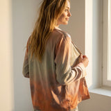 Side view of the Tæwas Sunset silk pyjama shirt, print shading from lilac to coral